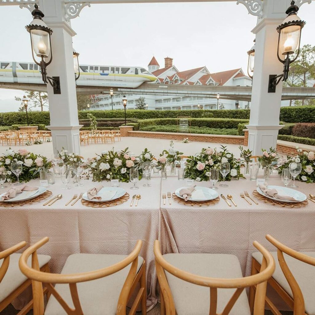 Gorgeous Wedding Ceremony and Reception decor at the Grand Floridian in Disney World with a view of the Monorail
