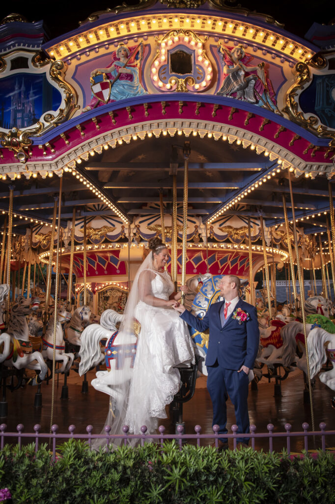 newly weds on the carousel in magic kingdom disney world for a private photoshoot
