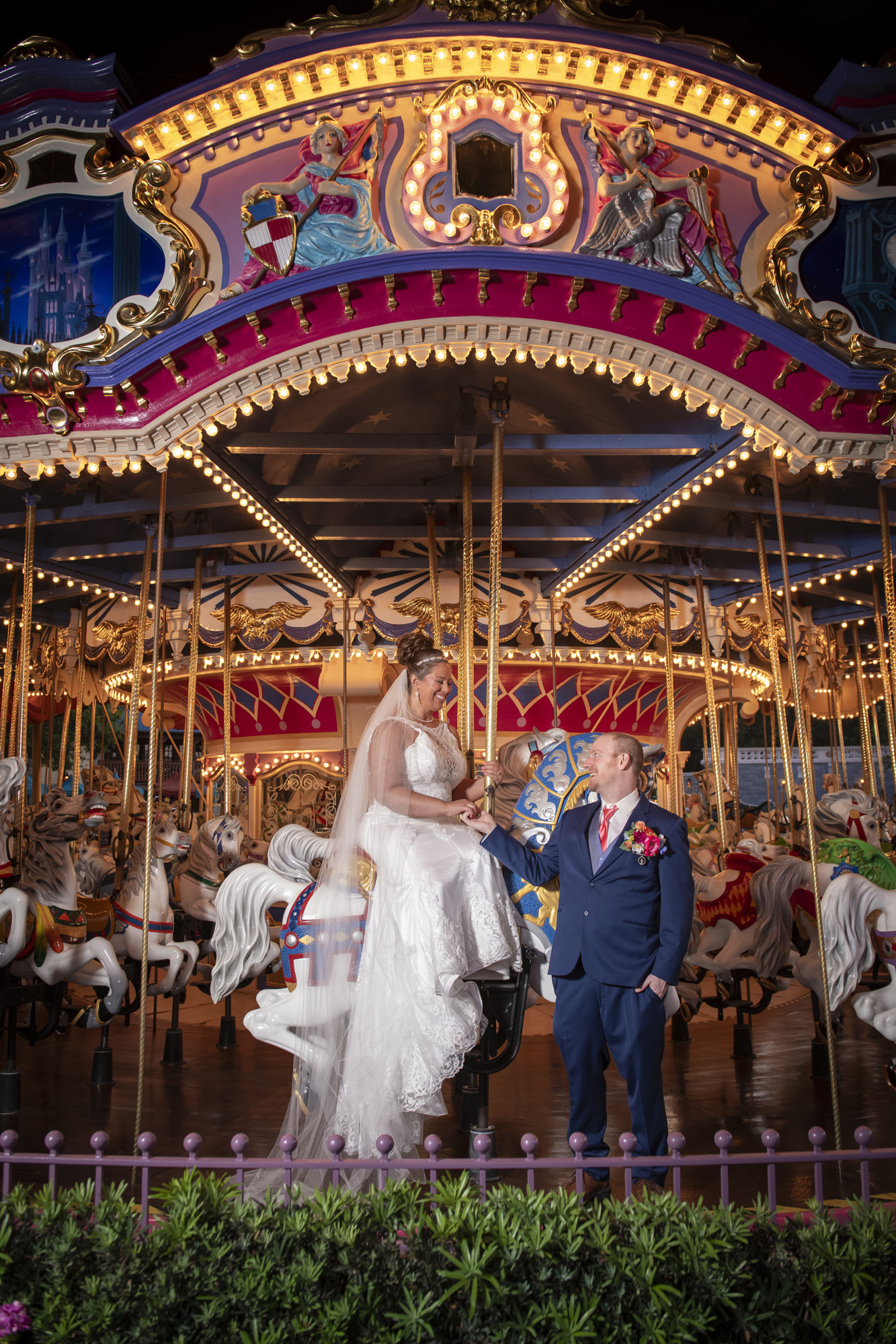 newly weds on the carousel in magic kingdom disney world for a private photoshoot